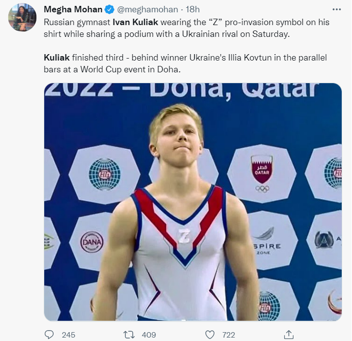 Russian gymnast stands on the podium with symbol supporting